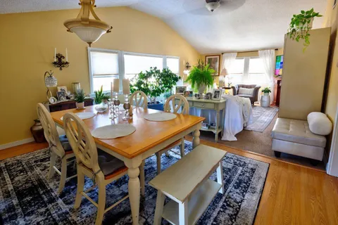 a view of a dining room with furniture and a chandelier