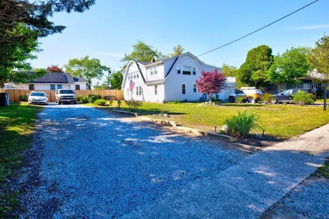 a front view of house with yard and trees