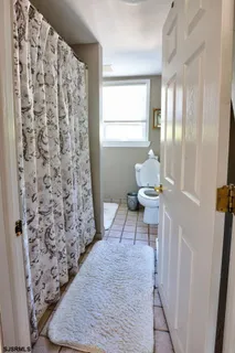 a bathroom with a toilet and a shower curtain