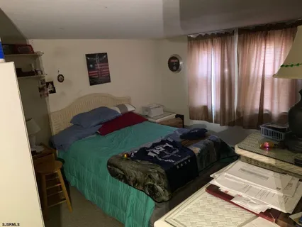 a bedroom with a bed and a flat tv screen