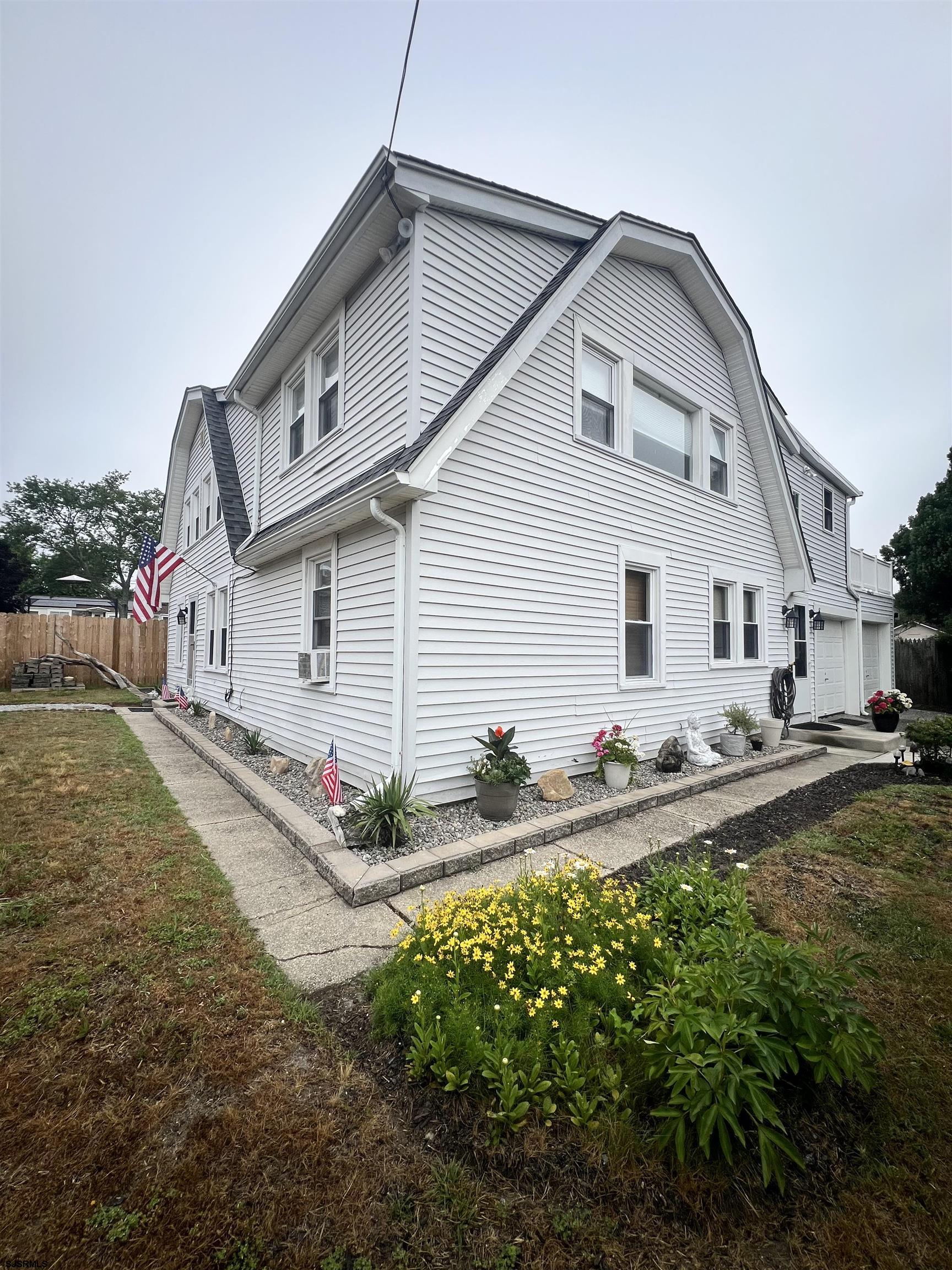 14 Lyndhurst Road Marmora, NJ 08223 - Photo 34 of 35 a view of a white house next to a yard with potted plants