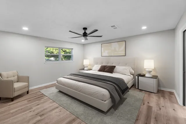 a spacious bedroom with a bed and a couch