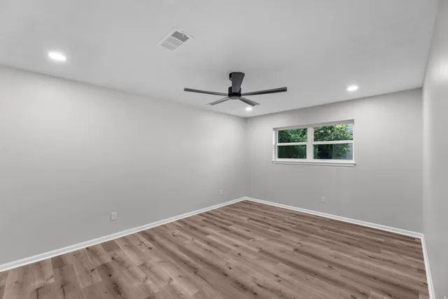 a view of a livingroom with a ceiling fan and window