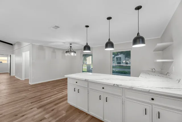 a spacious bathroom with double vanity and a sink