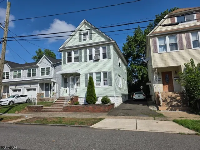 a front view of a residential houses with yard