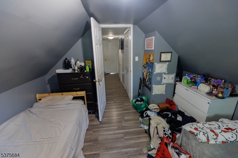 116 West 17th Street Linden, NJ 07036 - Photo 12 of 12 a bedroom with bed and wooden floor
