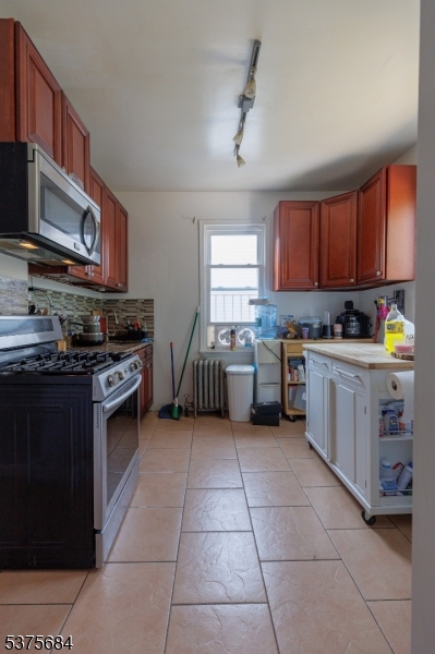 116 West 17th Street Linden, NJ 07036 - Photo 10 of 12 a kitchen with stainless steel appliances a stove sink and cabinets