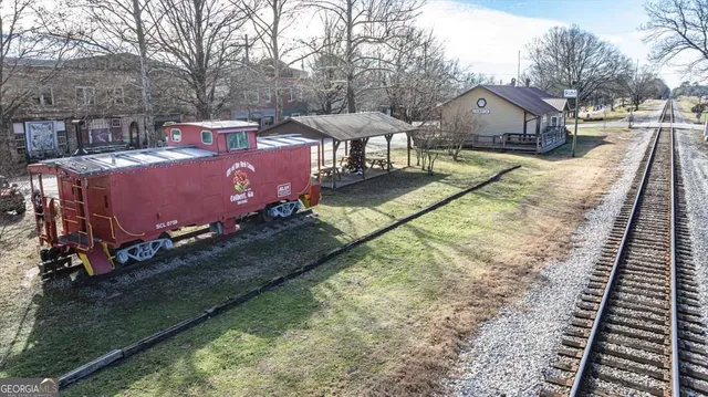an aerial view of a swimming pool with outdoor seating