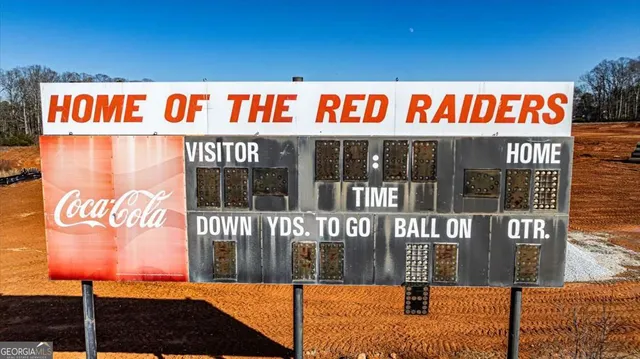 a sign that is sitting on a wooden wall