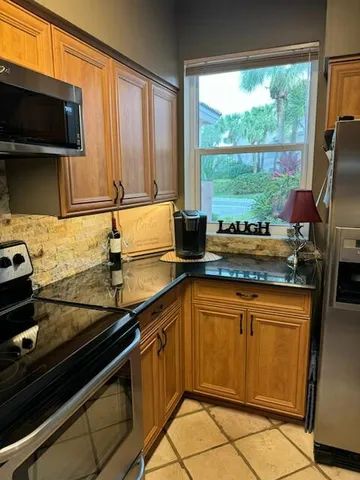 a kitchen with a sink stove and microwave