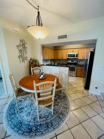 a dining room with a table and chairs