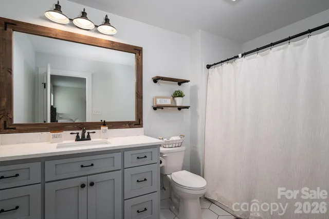 a view of walk in closet with clothes