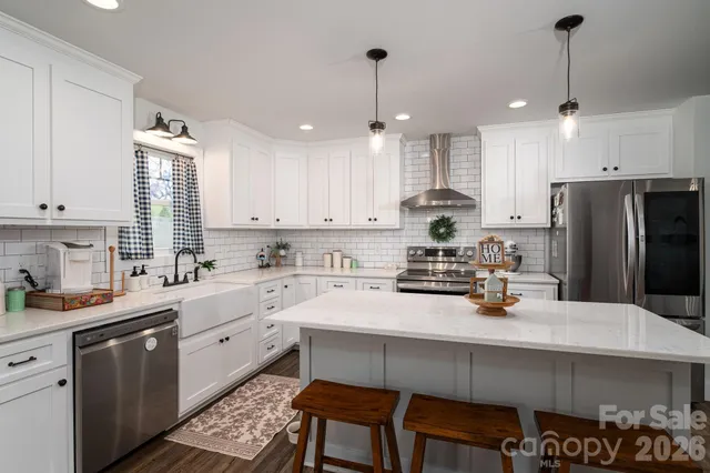 a kitchen with stainless steel appliances white cabinets and a stove