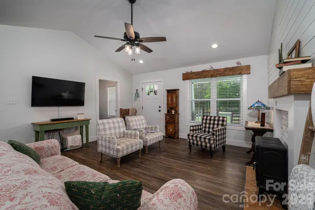a reading room with furniture a chandelier and a window
