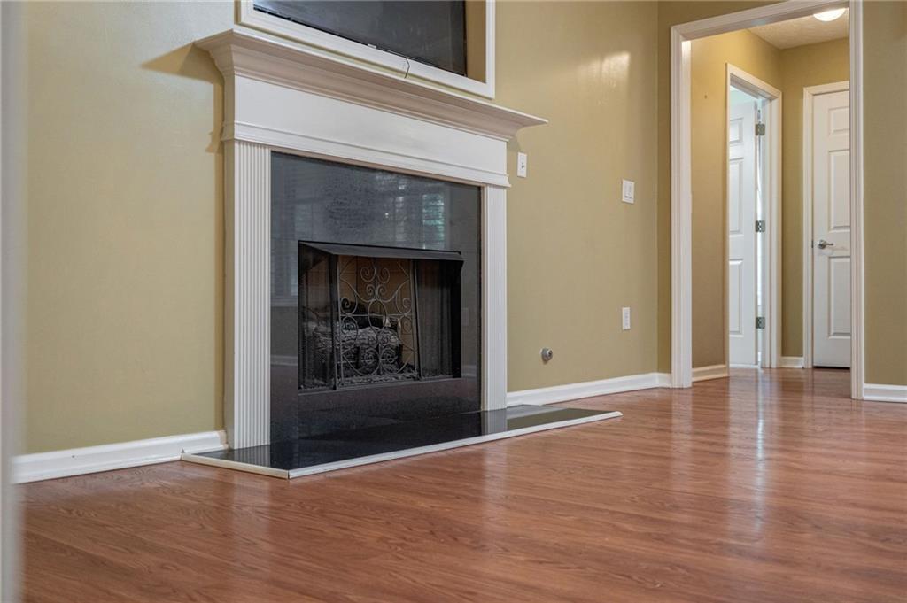 245 Memory Lane Winder, GA 30680 - Photo 10 of 62 a view of a livingroom with wooden floor and a fireplace