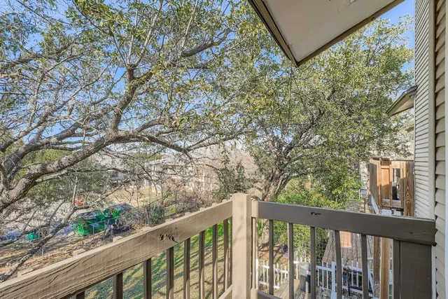 a view of a patio with couches and table and chairs and wooden fence