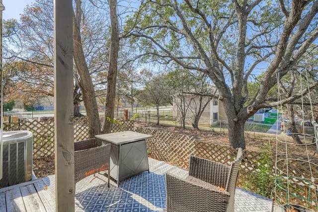 a view of house with patio and wooden fence