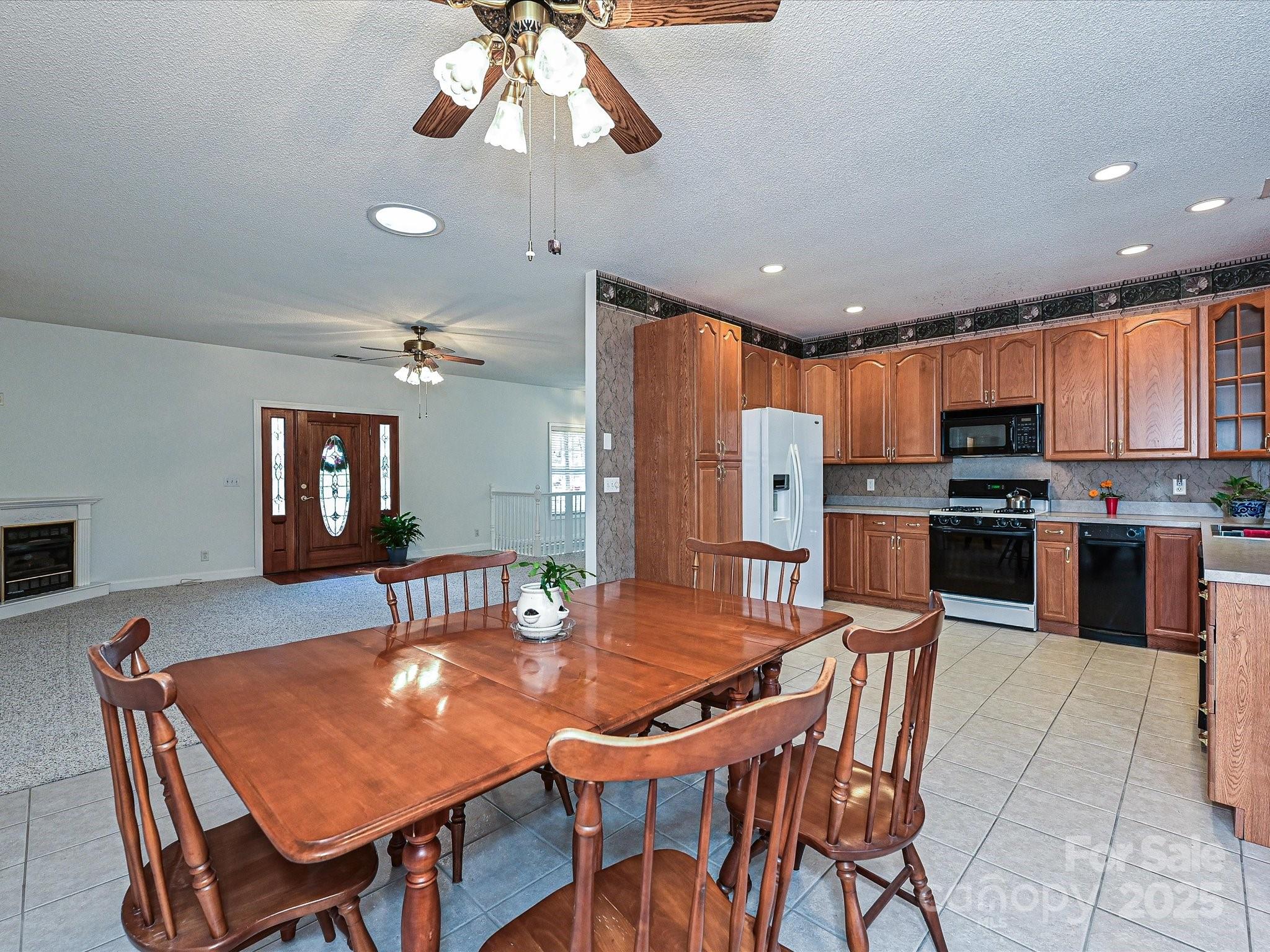 25040 Timberlake Drive Tega Cay, SC 29708 - Photo 21 of 40 an open kitchen with dining table and chairs