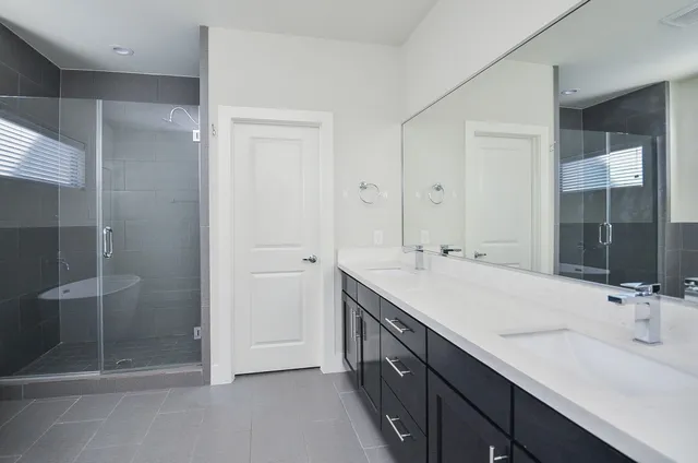 a bathroom with a double vanity sink and mirror