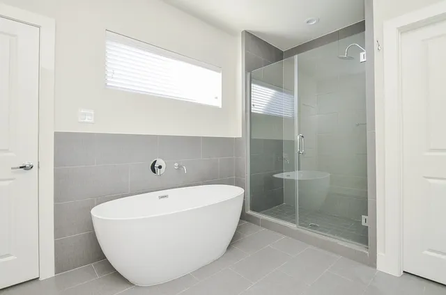 a bathroom with a bathtub and shower