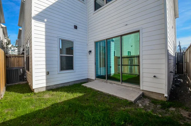 a view of a backyard with potted plants and a bench