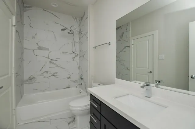 a bathroom with a sink a toilet and a bathtub