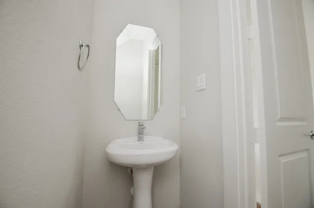 a bathroom with a sink and mirror
