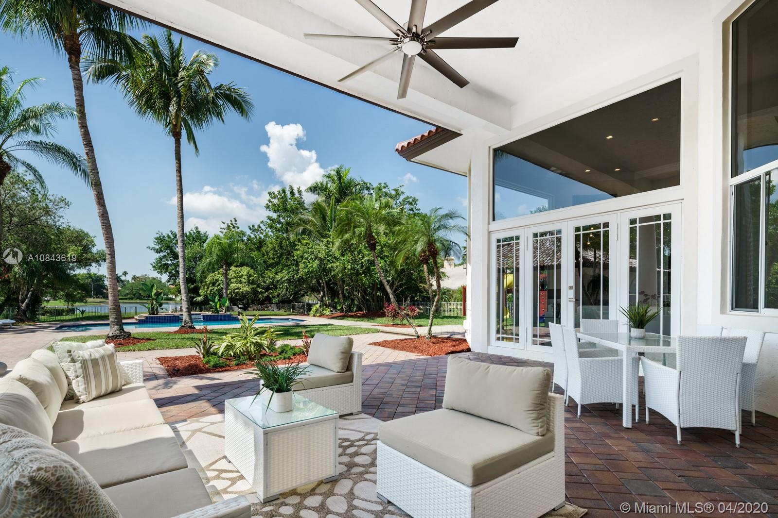 Large covered patio paired with Private lavish outdoor space overlooking the pool and long lake view