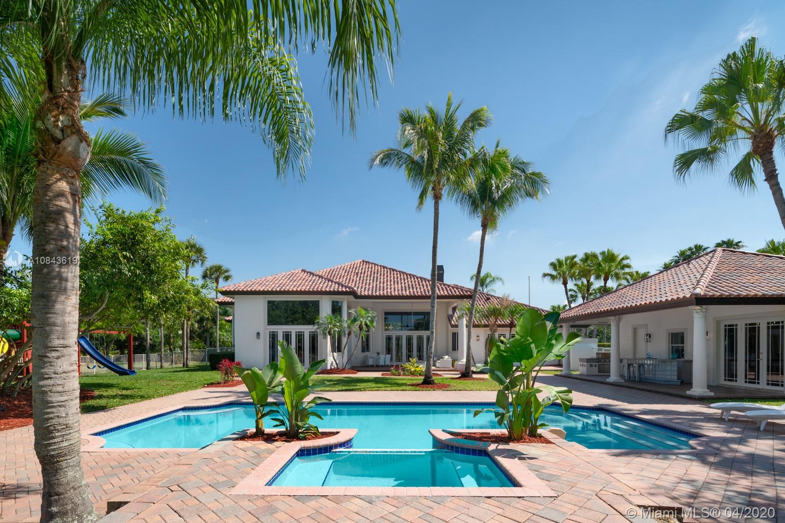 2725 Windmill Ranch Road Weston, FL 33331 - Photo 13 of 42 Private pool desk, heated pool, spa, guest house, summer kitchen, large covered patio with plenty of space to relax, entertain and children to play. All overlooking the glorious long lake view.