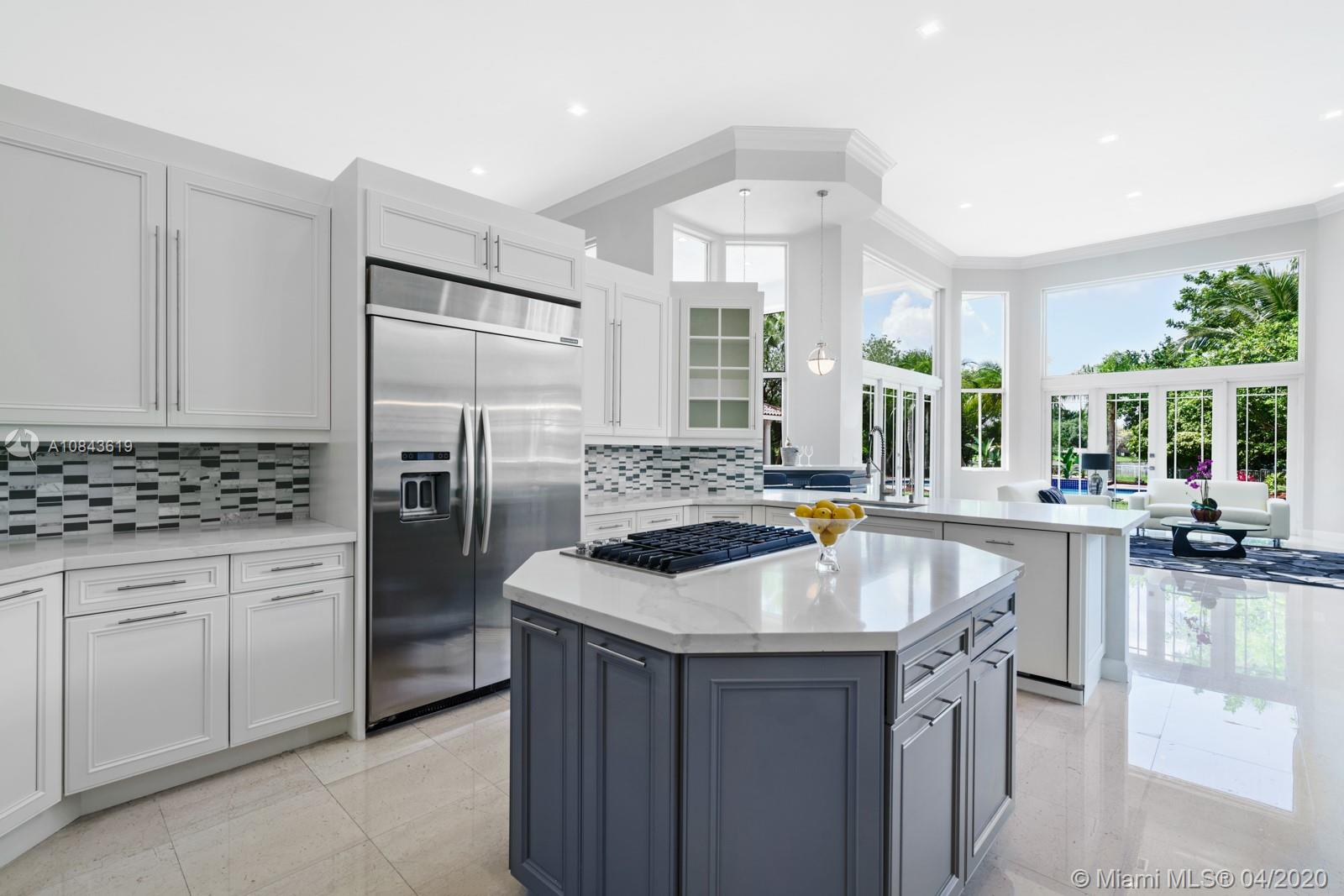 2725 Windmill Ranch Road Weston, FL 33331 - Photo 7 of 42 Remodeled Open Island chefs kitchen. New gas cook-top, quartz counter-tops, glass backsplash, butler pantry, double oven, stainless steel appliances.