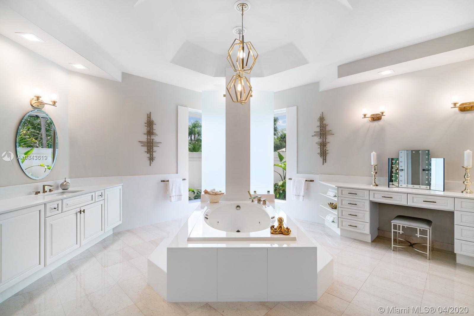 2725 Windmill Ranch Road Weston, FL 33331 - Photo 9 of 42 Spa like Master bathroom, His and hers sink and water closet. Whirlpool bath tub and separate walk in shower overlooking glass enclosure lush tropical paradise.