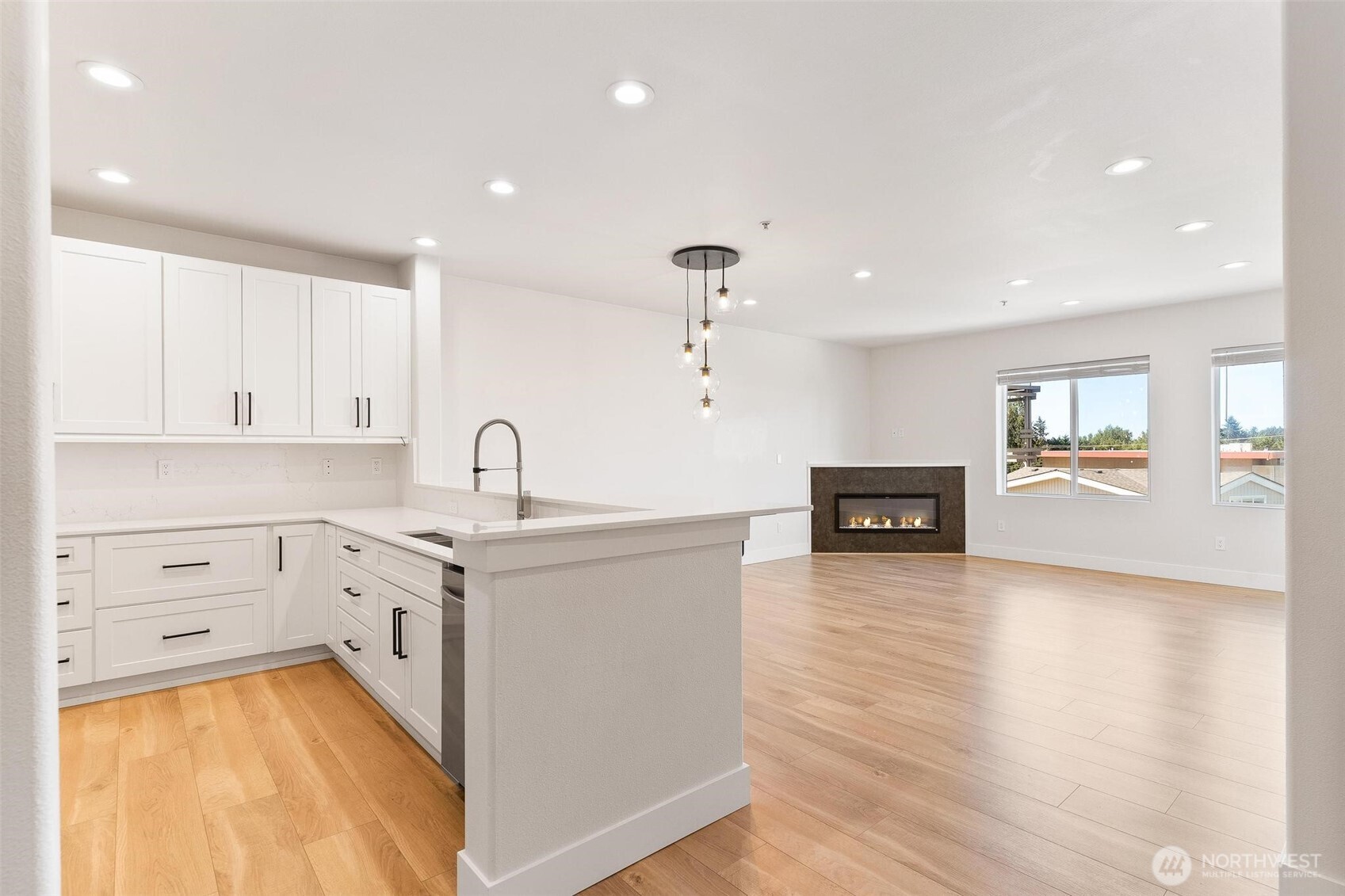 14915 38th Drive Southeast, Unit F3011 Bothell, WA 98012 - Photo 2 of 40 a kitchen with sink cabinets and wooden floor