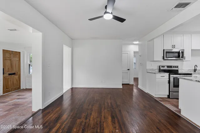 a view of kitchen with refrigerator and window