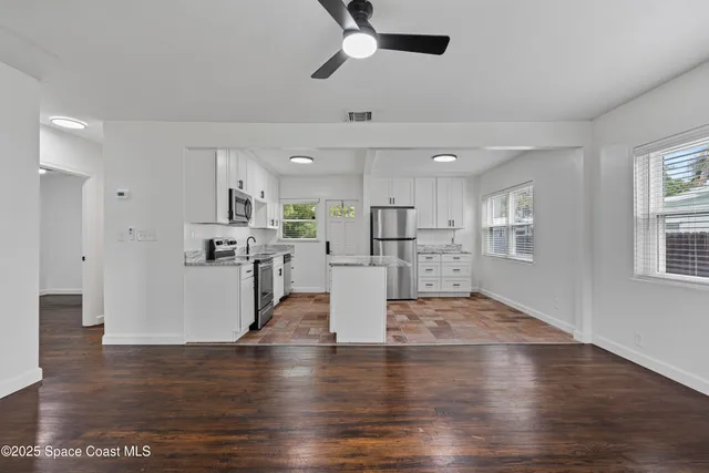 a kitchen with refrigerator and cabinets