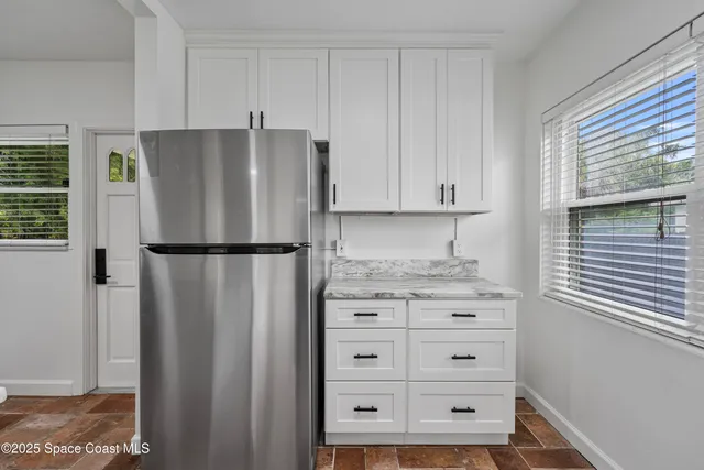 a kitchen with cabinets stainless steel appliances a sink and a stove