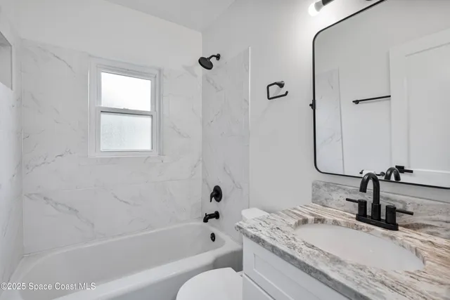 a view of a room with wooden floor and windows