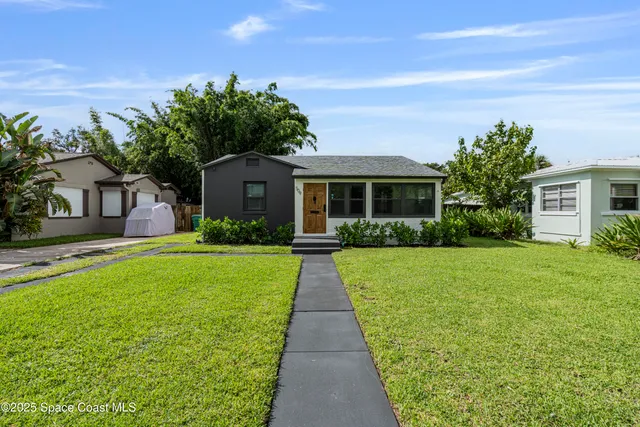 a front view of house with yard and green space