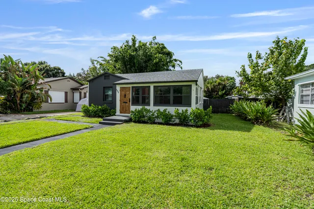 a front view of house with yard and green space