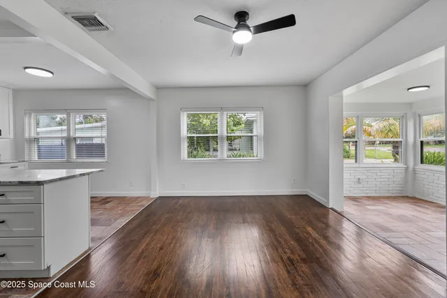 a view of kitchen with refrigerator microwave and stove top oven