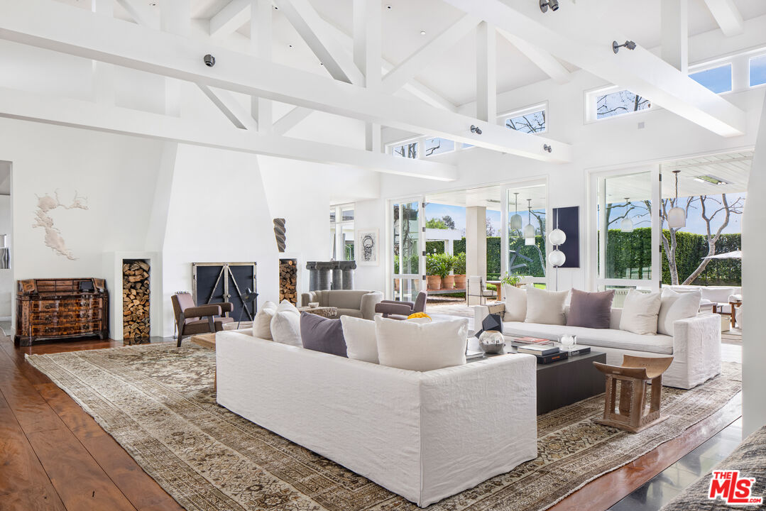 1192 Cabrillo Drive Beverly Hills, CA 90210 - Photo 11 of 43 a living room with furniture large window and wooden floor