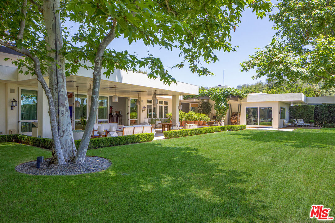 1192 Cabrillo Drive Beverly Hills, CA 90210 - Photo 27 of 43 a front view of a house with a garden