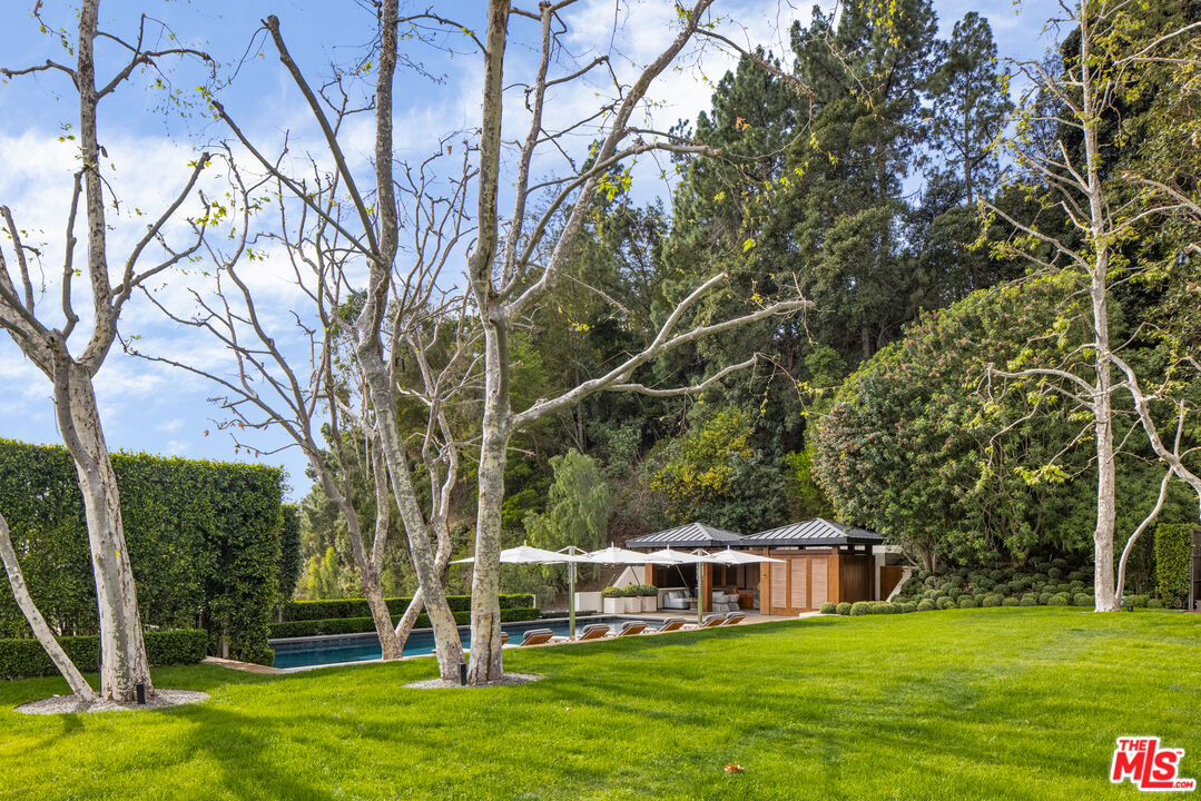 1192 Cabrillo Drive Beverly Hills, CA 90210 - Photo 30 of 43 a view of house with garden and trees