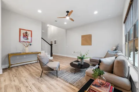a view of kitchen with stainless steel appliances granite countertop a stove a sink dishwasher and a refrigerator with wooden floor