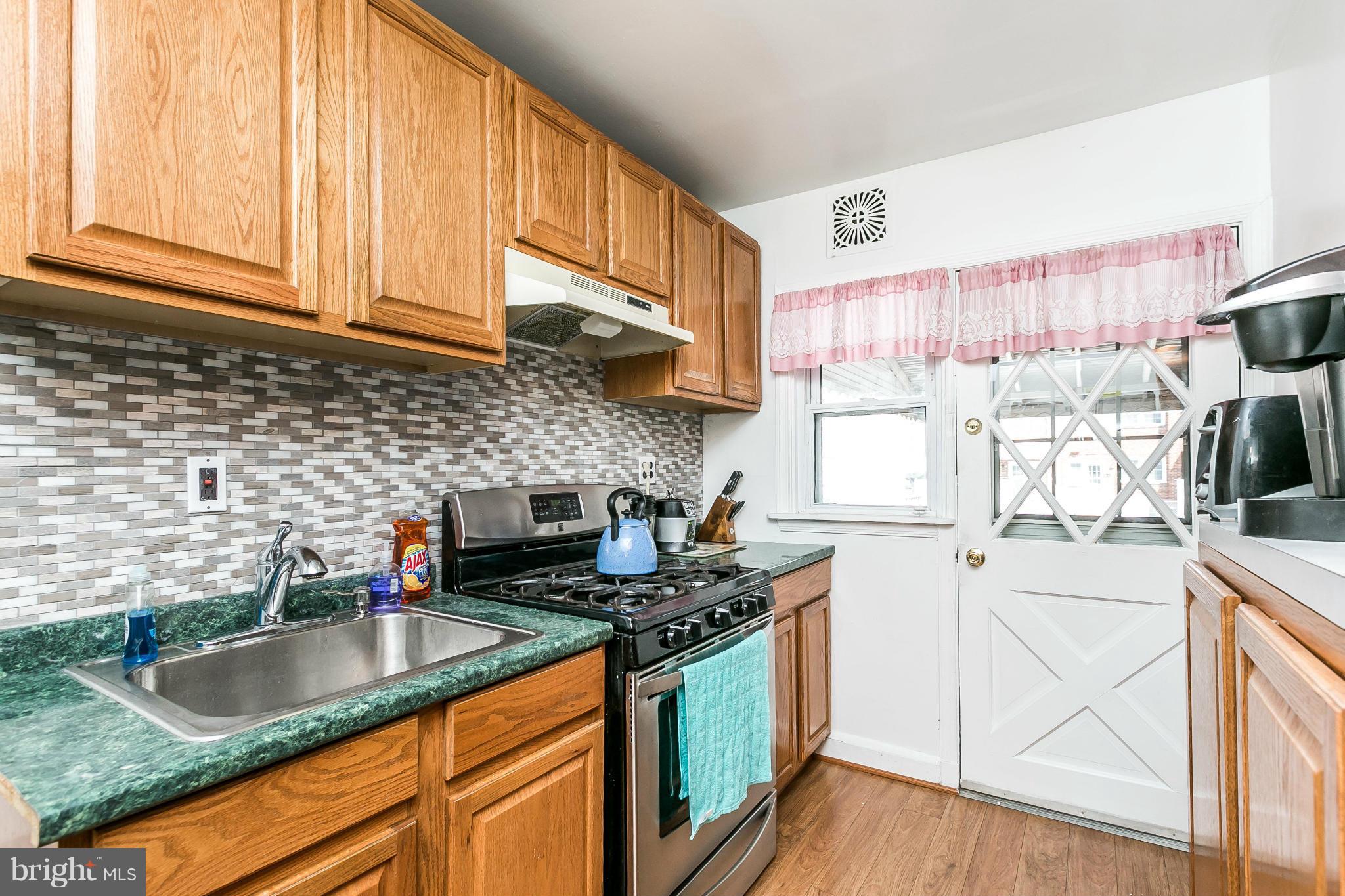 428 Trappe Road Baltimore, MD 21222 - Photo 11 of 30 a kitchen with stainless steel appliances granite countertop a sink stove and cabinets