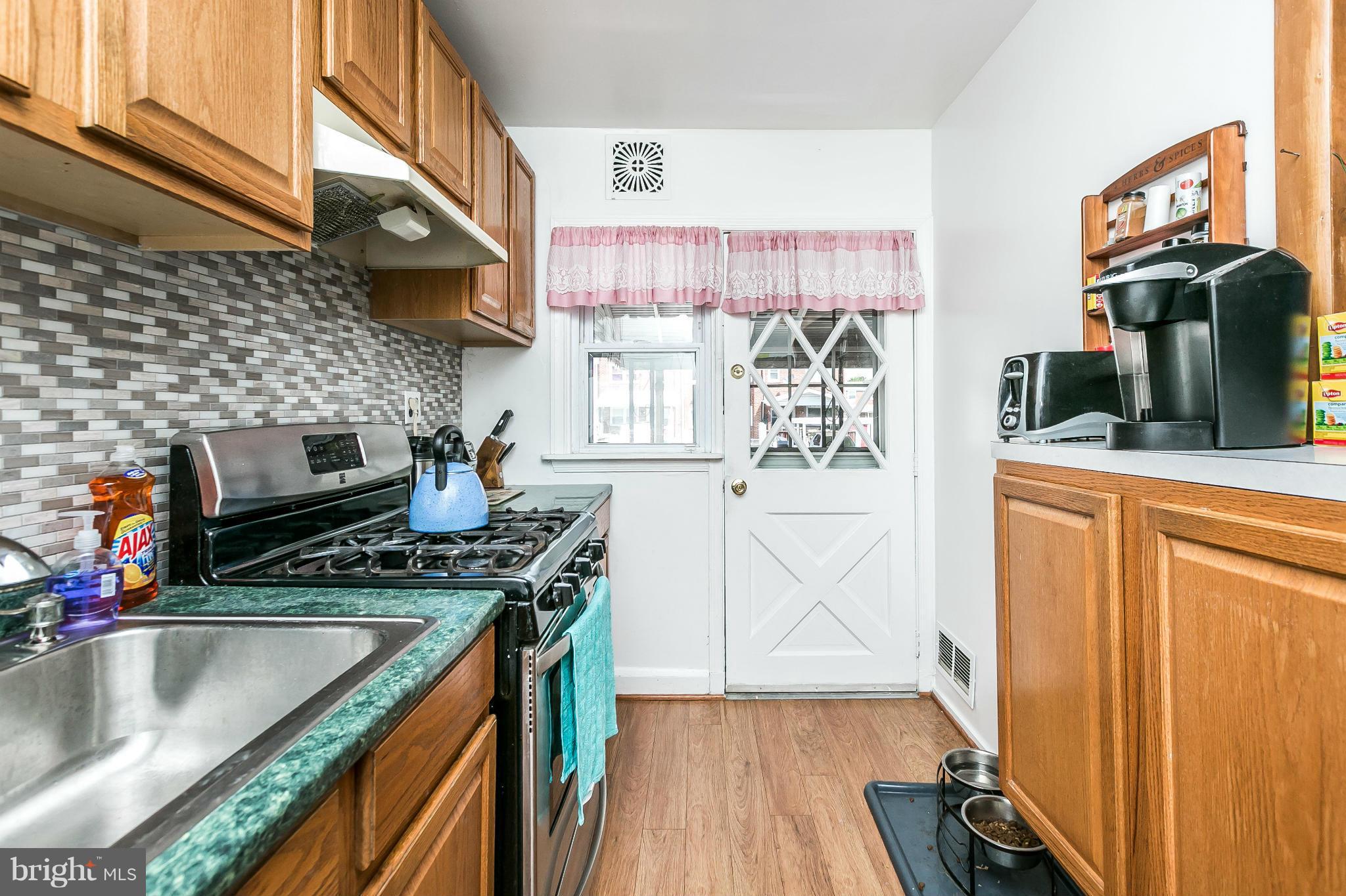428 Trappe Road Baltimore, MD 21222 - Photo 12 of 30 a kitchen with stainless steel appliances granite countertop a stove a sink and a microwave
