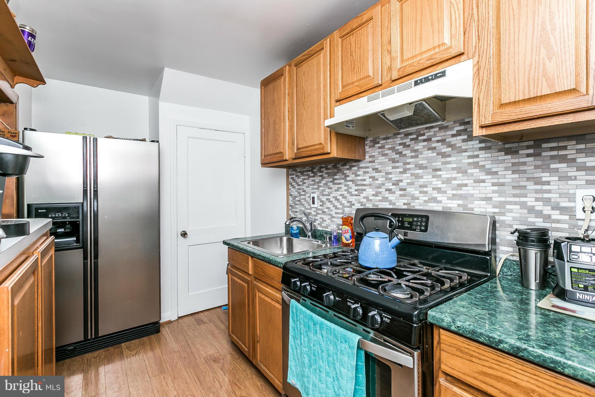 428 Trappe Road Baltimore, MD 21222 - Photo 13 of 30 a kitchen with granite countertop a stove and a refrigerator