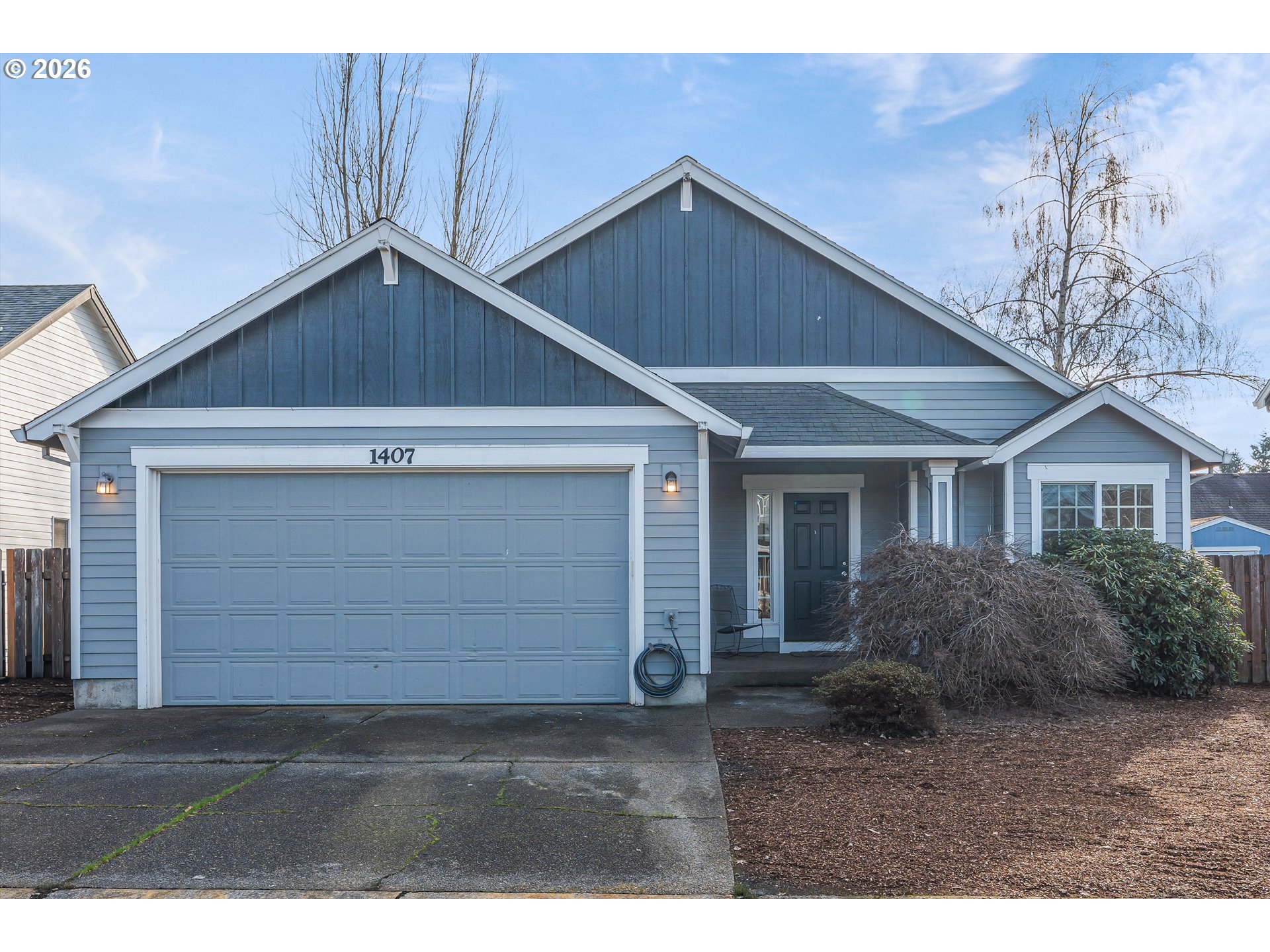 1407 Southeast 7th Avenue Canby, OR 97013 - Photo 1 of 31 a front view of a house with a yard