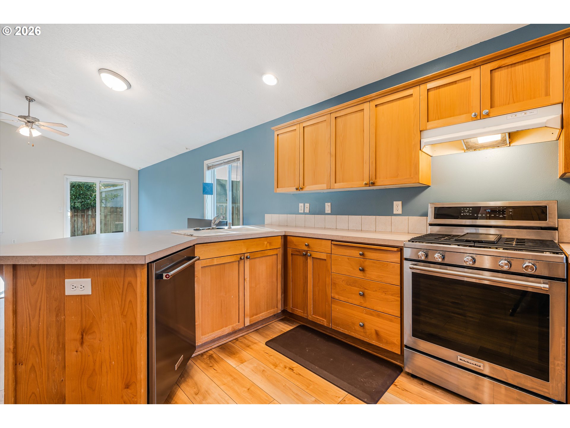 1407 Southeast 7th Avenue Canby, OR 97013 - Photo 11 of 31 a kitchen with stainless steel appliances granite countertop a stove a sink and a microwave