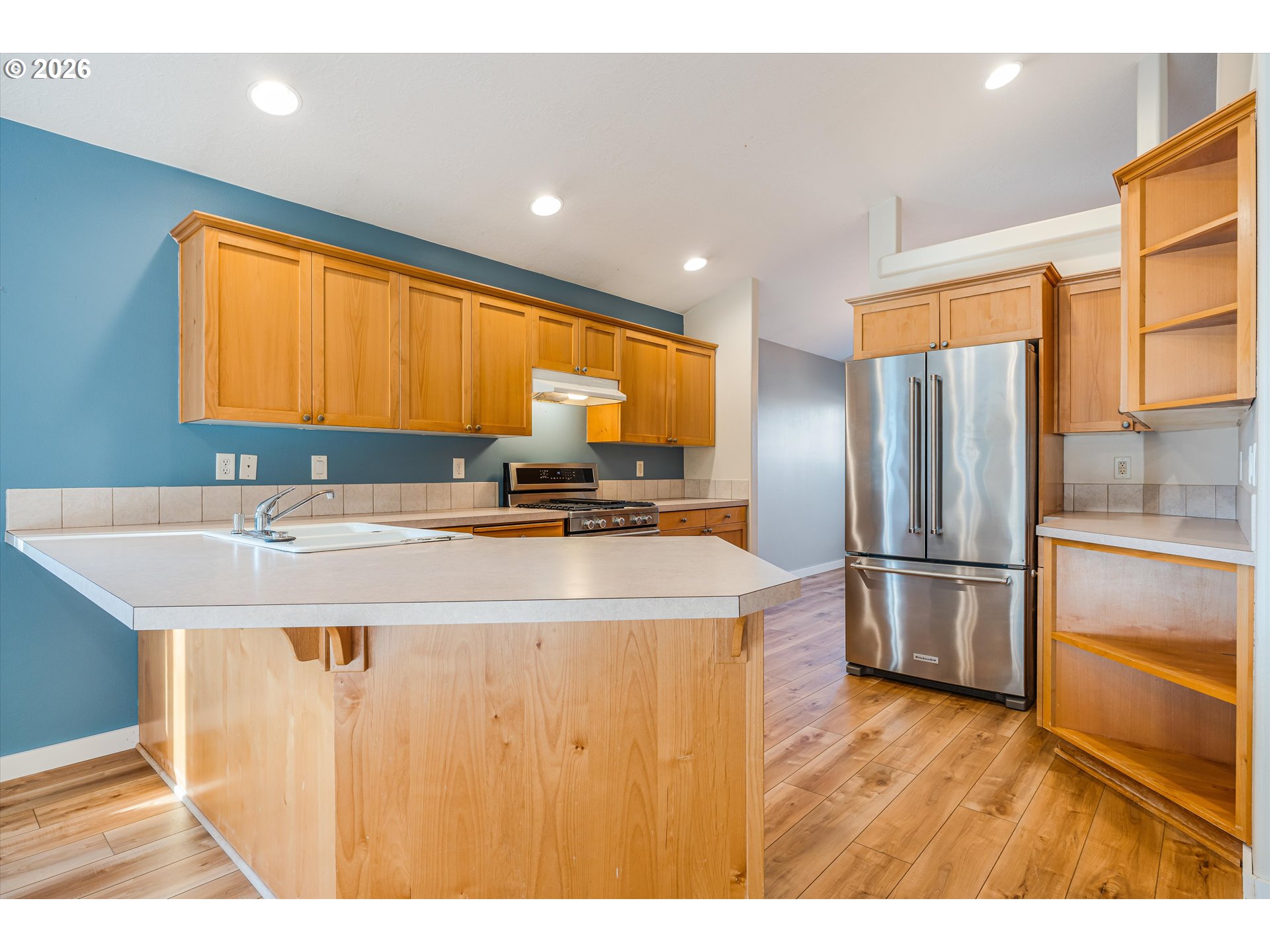 1407 Southeast 7th Avenue Canby, OR 97013 - Photo 13 of 31 a kitchen with kitchen island a sink appliances and cabinets