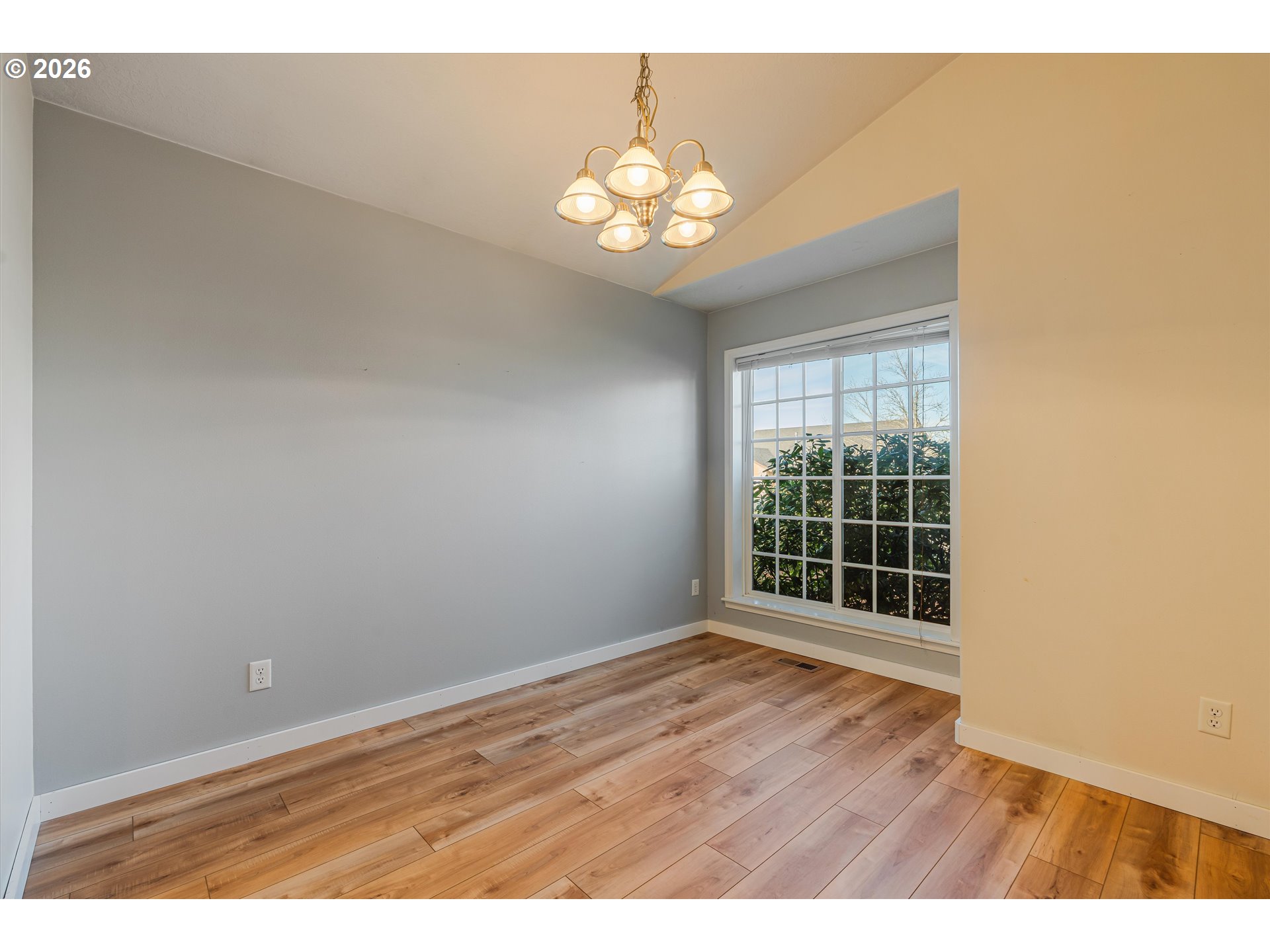 1407 Southeast 7th Avenue Canby, OR 97013 - Photo 6 of 31 a view of an empty room with wooden floor and a window